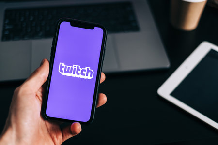 Twitch logo on the smartphone screen in hand.のeditorial素材
