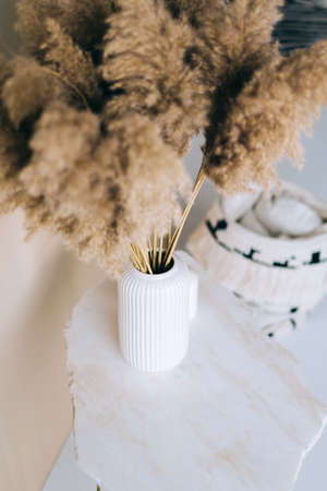 Dried flowers spikelets pampas in white vase on on a marble table.の写真素材