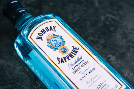 Bombay Sapphire bottle close up shot, white dry gin on black background.