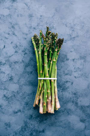 Asparagus bunch isolated on blue background, top view.の写真素材