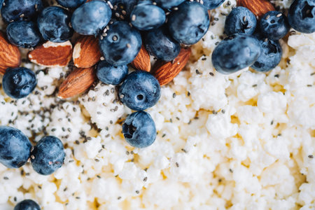 Crumbly curd with blueberries, almonds and chia seeds, close up.の写真素材