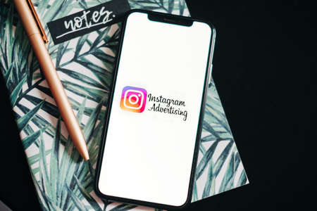 Instagram ads logo on the smartphone screen.のeditorial素材