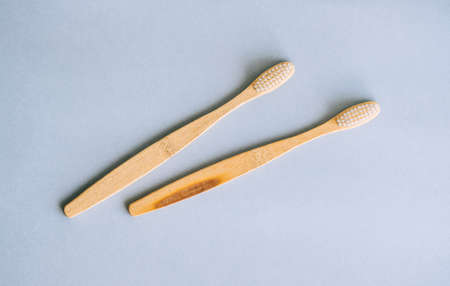 Bamboo toothbrushes making with natural materials, isolated on gray background, close-up.