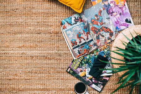 Reading comic books and manga on the carpet at cozy home.のeditorial素材