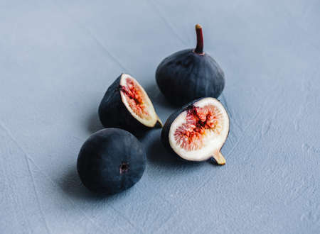 Fresh ripe figs on blue background, close-up.の写真素材