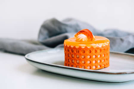 Orange dessert with biscuit, cheese filling and cream.の写真素材