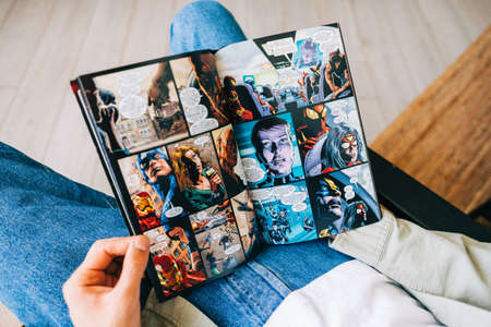 Man reads comic book in living room at home.のeditorial素材