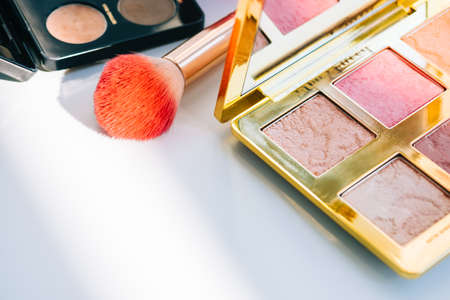 Cosmetic brush and eyeshadow palette for make up on white table, beauty accessories.の写真素材