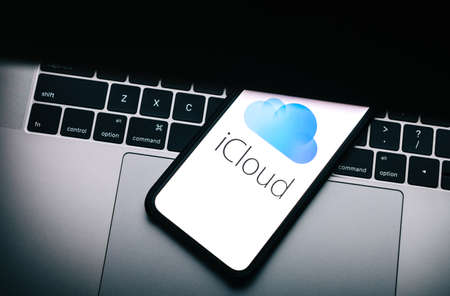 iPhone with apple iCloud logo on the screen.のeditorial素材