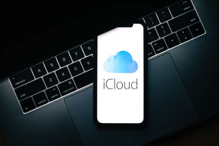 iPhone with apple iCloud logo on the screen.のeditorial素材