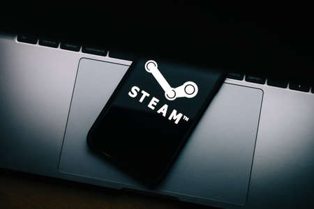 Steam logo on the smartphone screen.のeditorial素材