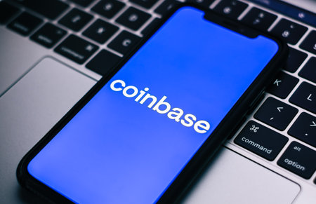 Coinbase logo on smartphone screen.のeditorial素材