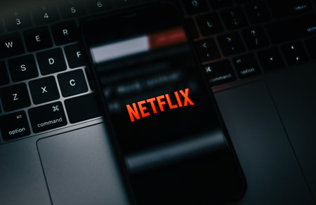 Smartphone with netflix logo on the screen.のeditorial素材