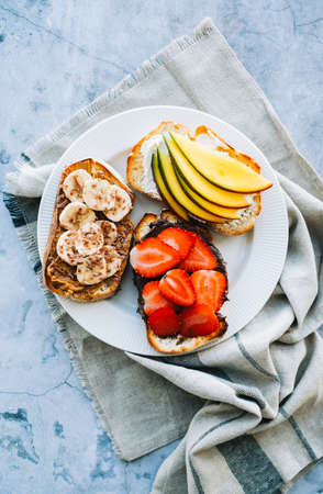 Delicious fruit toasts mix for breakfast, lunch or snack. Healthy foodの写真素材