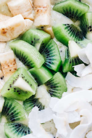 Sliced banana, kiwi and coconut chips, close up shot. Healthy nutrition, fruit mix.の写真素材