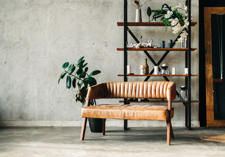 Interior of minimalist living room with shelving and brown leather couch.