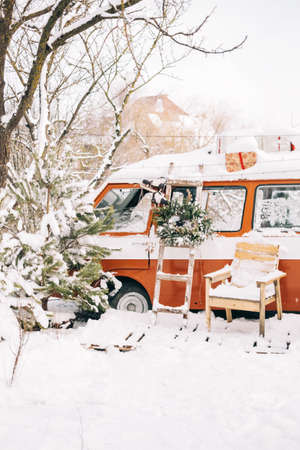 Snow covered van in winter camp, with Christmas decoration.の写真素材