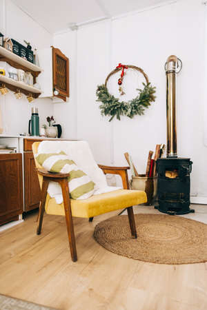 County house kitchen interior, with armchair and fireplace, cozy winter decoration.の写真素材