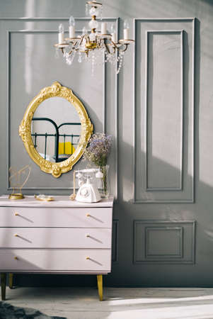 Interior of contemporary living room with dresser and vintage mirror on a wall.の写真素材