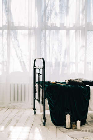Empty bed near big window in sunny morning.の写真素材