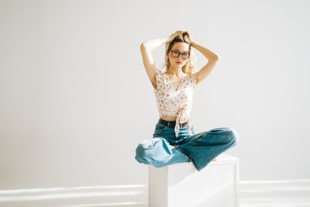 Portrait of attractive caucasian young woman in eyeglasses with blonde hair isolated on white background.の写真素材
