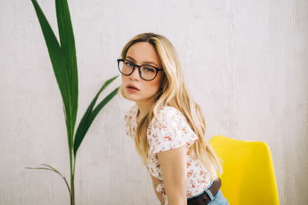 Portrait of attractive caucasian young woman in eyeglasses.