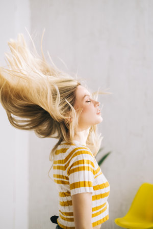 Young attractive caucasian woman shaking her blonde hair.の写真素材