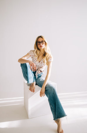 Portrait of attractive caucasian young woman in eyeglasses with blonde hair isolated on white background.の写真素材