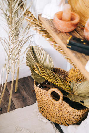 Interior detail of bedroom in eco style, decoration on a wooden shelf.の写真素材