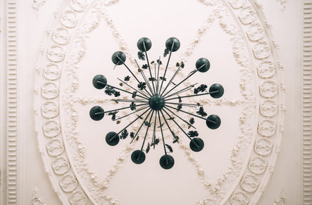 Beautiful vintage chandelier in the living room with ornamental ceiling.の写真素材