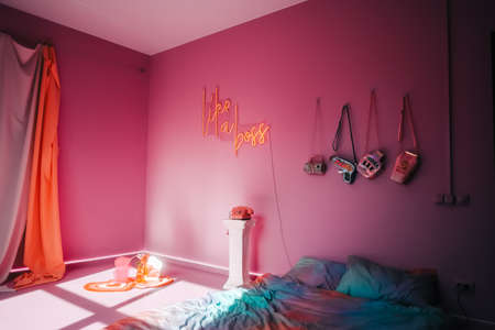 Interior of bright bedroom with pink walls and trendy decoration.の写真素材