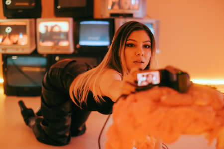 Young caucasian woman dancer making self video with new dance moves on a camera.の写真素材