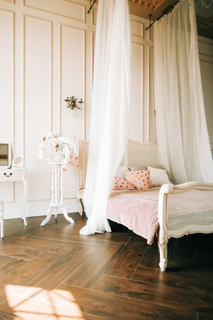 Interior of bright bedroom with large bed.の写真素材