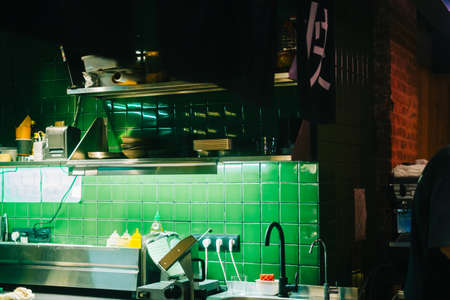 Kitchen table with professional equipment in a public cafe.の写真素材