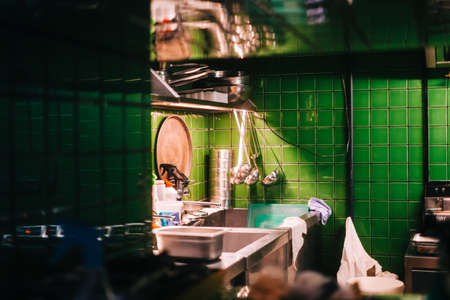 Kitchen table with professional equipment in a public cafe.の写真素材