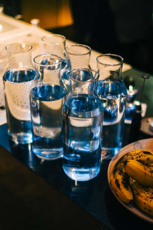 Glass bottles with water on the bar counter in Asian restaurant.の写真素材