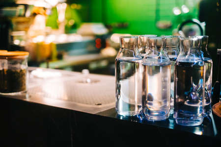 Glass bottles with water on the bar counter in Asian restaurant.の写真素材