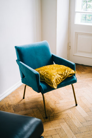 Blue armchair with pillow in bright living room.の写真素材