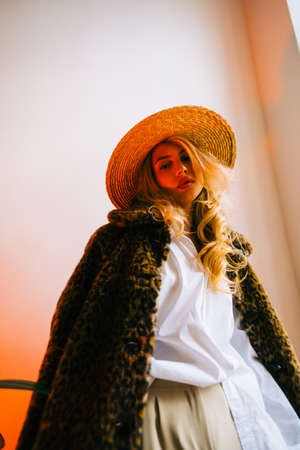 Portrait of attractive caucasian woman in a hat wearing fur coat and stylish outfit.の写真素材