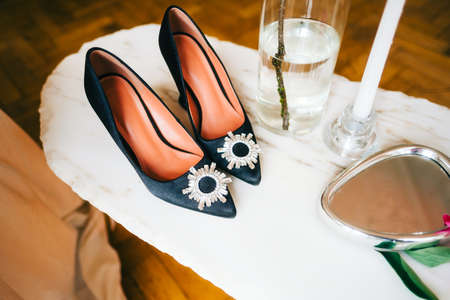 Womens heeled black shoes on the table, close up.の写真素材