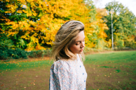 Portrait of attractive caucasian woman posing in the autumn park.の写真素材