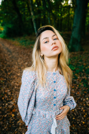 Portrait of attractive caucasian woman posing in the autumn park.