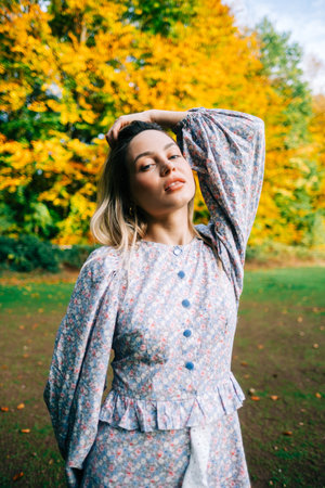 Portrait of attractive caucasian woman posing in the autumn park.の写真素材