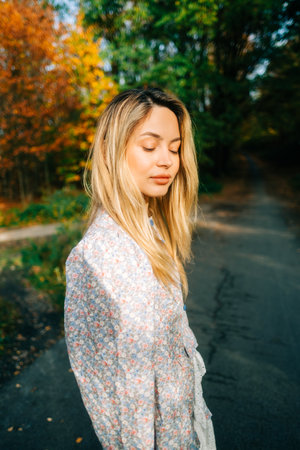 Portrait of attractive caucasian woman posing in the autumn park.の写真素材