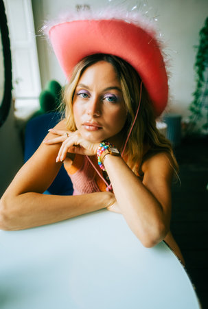 Portrait of attractive caucasian woman fashion model with blonde hair in pink cowboys hat , posingの写真素材
