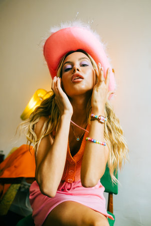 Portrait of attractive caucasian woman fashion model with blonde hair in pink cowboys hat , posingの写真素材