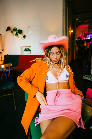 Portrait of attractive caucasian woman fashion model with blonde hair in pink cowboys hat , posingの写真素材