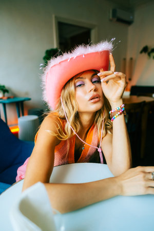 Portrait of attractive caucasian woman fashion model with blonde hair in pink cowboys hat , posingの写真素材