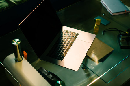 Laptop computer on glass table. Freelancer home workspace office.の写真素材