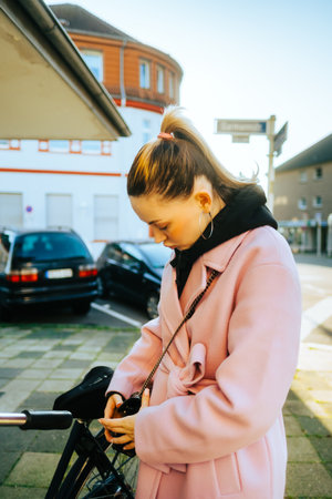 Young attractive caucasian woman ride on bicycle in the city street.の写真素材